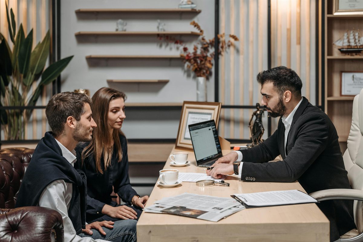 An advisor reviewing an SBA file with a couple